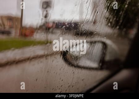 Raindrops on Car Side Window Glass Close Up Stock Photo