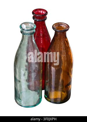 Three empty glass bottles in different colors stand together against a white background. These bottles can be used for various purposes in home decor Stock Photo