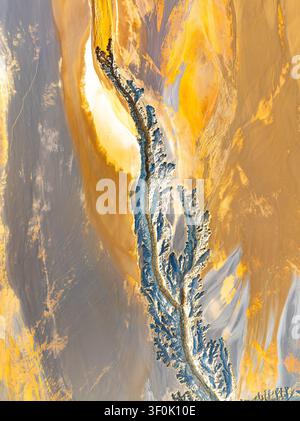 Aerial abstract background of fractal landscape textures at Riotinto Mines, Huelva, Spain, showing natural patterns in vivid ochre, gold, and blue min Stock Photo