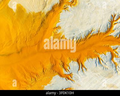 Aerial abstract background of fractal landscape texture at Riotinto Mines, Huelva, showing vivid ochre mineral deposits and branching erosion patterns Stock Photo