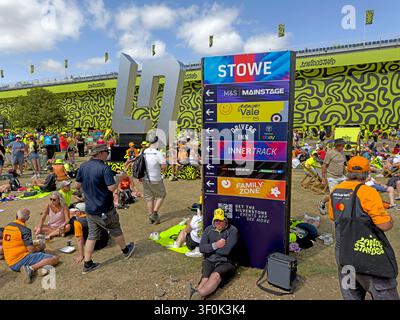LN Crowds relax beneath the brightly decorated Landostand grandstand near Stowe Corner during Silverstone’s 2026 British Grand Prix Stock Photo