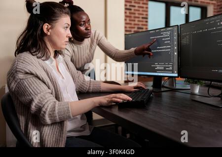 Blockchain engineer identifying network security code mistake Cybernetics developers engineering system updates and processing data blocks uploaded by artificial intelligence. Stock Photo