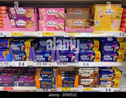 Choice of Sweet treats and biscuits on Supermarket shelves, UK Stock Photo