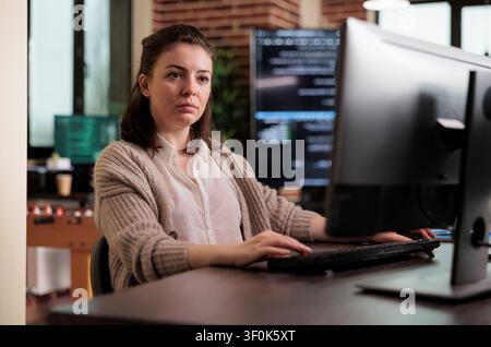 Developer engineering artificial intelligence defense system, cyber officer encrypting big chunks of data in order to secure important files. Stock Photo