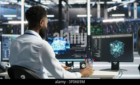 Supervisor supervising server facility systems engineer working with AI neural network models to set up hardware. Stock Photo