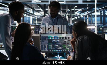 Server room coworkers doing planning solutions, working with node tree software to review data sets. Stock Photo