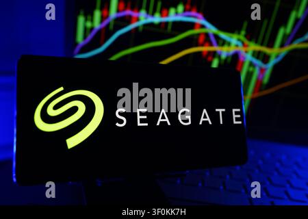 Seagate Data Storage Technology Company Logo on Smartphone Display with Stock Market Performance Chart Stock Photo