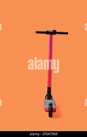 Pink modern electric kick scooter on orange background Stock Photo