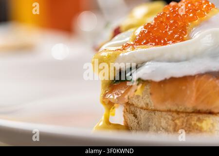 Close-up of eggs benedict with salmon roe and melting hollandaise Stock Photo
