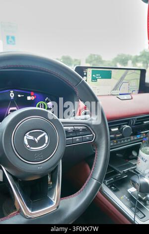 PLANO, TX, USA - JULY 06, 2026: The interior of a Mazda CX-70 PHEV is depicted with a focus on its steering wheel and modern dashboard display. The Ma Stock Photo