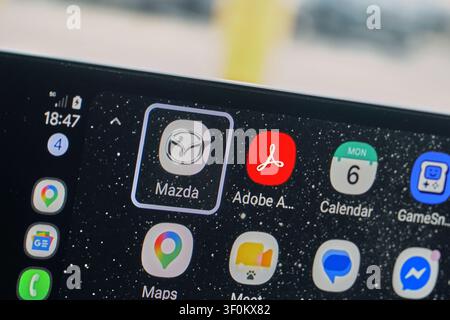PLANO, TX, USA - JULY 06, 2026: Close-up of a Mazda CX-70 display featuring various apps including Mazda, Adobe Acrobat, and Maps within the car inter Stock Photo