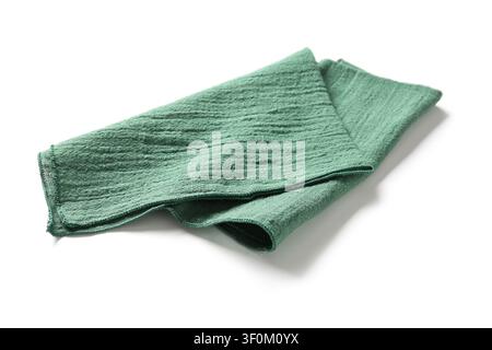 Folded green kitchen towel or cloth napkin with textured fabric, isolated on a clean white background Stock Photo