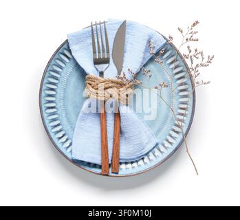Ceramic blue plate with light blue napkin, rope, cutlery, and dried flower branch, isolated on a white background Stock Photo