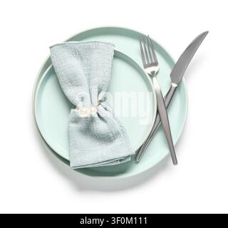 Elegant table setting with light blue plates a folded napkin with a pearl ring and silver cutlery isolated on white background Stock Photo