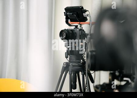 Poznan, Greater Poland, Poland, July 9, 2026, Professional digital cinema camera mirrorless rig external monitor tripod recording podcast studio. A co Stock Photo