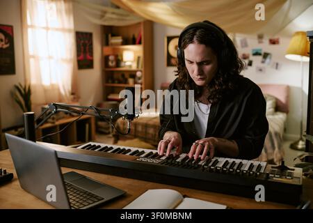 Man Recording Music at Home Studio for Content Creation Stock Photo