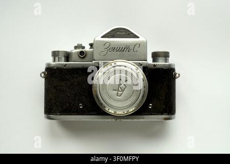 Front view of vintage Soviet 35mm film SLR camera Zenit-S with lens cap on, isolated on white background Stock Photo