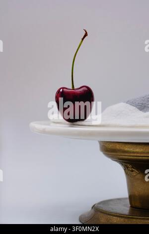 Dark red cherry on a cake tray Stock Photo