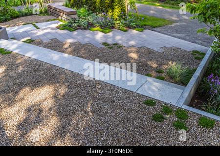 Modern garden design featuring gravel paths and geometric paving stones Stock Photo
