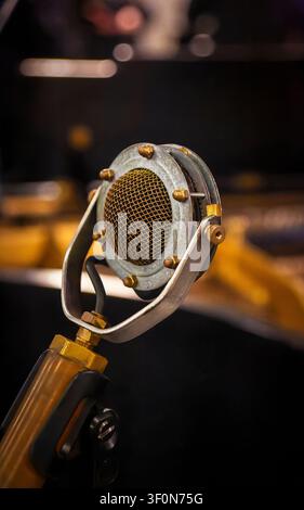 Vintage Soviet condenser microphone on a stand at a live music performance. Stock Photo