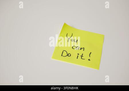 Yellow Sticky Note with You Can Do It on White Background Stock Photo