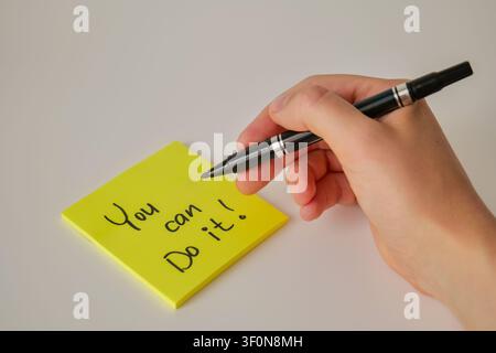 Hand Writing You Can Do It on Yellow Sticky Note Stock Photo