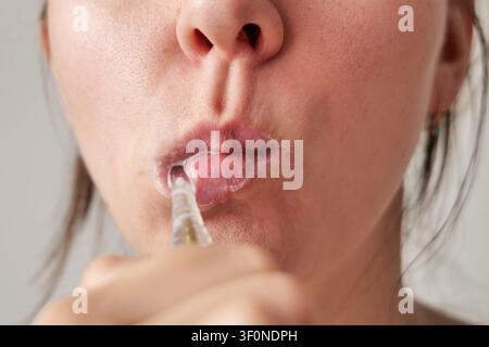 Young Woman Brushing Teeth with Toothbrush Stock Photo