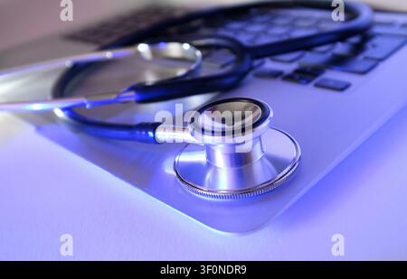 doctor's stethoscope on laptop keyboard Stock Photo