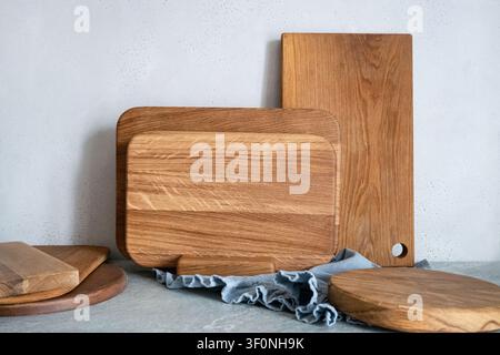 Set of wooden cutting boards arranged on kitchen surface. Natural rustic cooking background with texture for food preparation, kitchen tools and culin Stock Photo