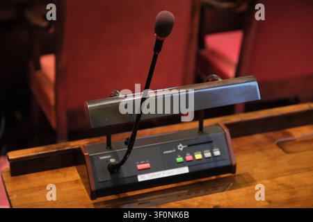 Stockholm, Sweden-Nov.28th 2025: Close-up view of a gooseneck microphone and voting console on a wooden desk inside Stockholm City Hall. Stock Photo