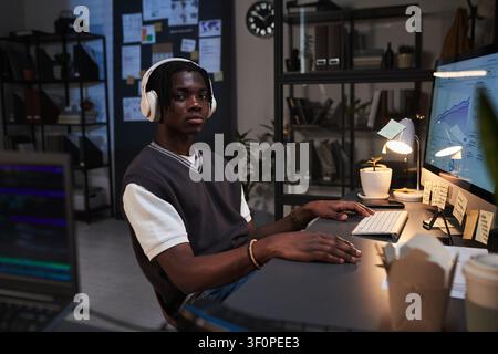 Portrait of Young Adult Black Male Employee Working on Data Analysis at Office Stock Photo
