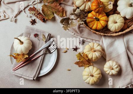 Thanksgiving table flatlay with white pumpkin and cutlery.. Stock Photo