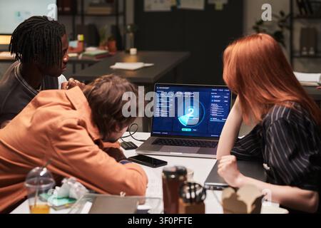Diverse Coworkers Reviewing Project Dashboard in Office Meeting Stock Photo