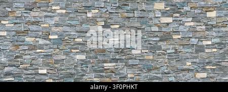 Mosaic wall cladding in stone look - panorama of a facade Stock Photo