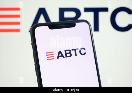 Caption: Paris, France - July 9, 2026: A smartphone displaying the ABTC logo on the screen against a background with the company logo. Stock Photo