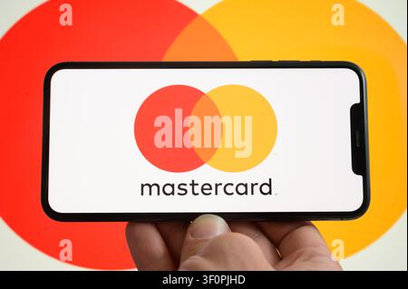 Paris, France - July 9, 2026: A smartphone displaying the Mastercard logo on the screen against a background with the company logo. Stock Photo