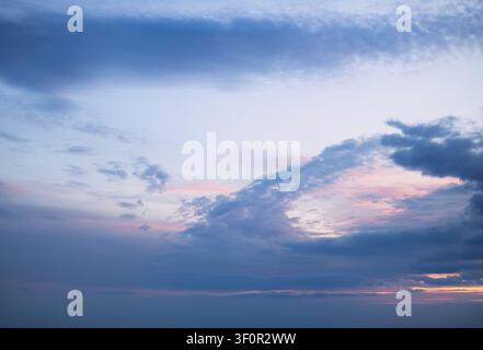a beautiful sunrise sky with a gradient from deep blue to soft pink and gold Stock Photo
