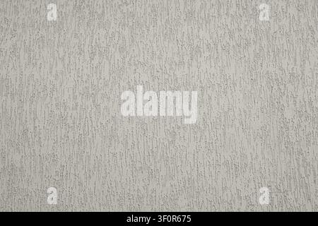 Textured plaster wall background with vertical stucco pattern and neutral gray finish Stock Photo