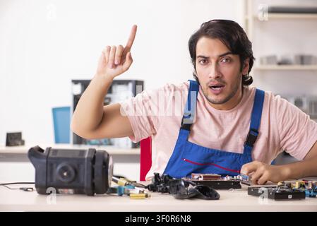 Young male contractor repairing computer Stock Photo