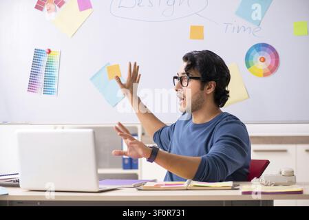 Young handsome designer working at the project Stock Photo