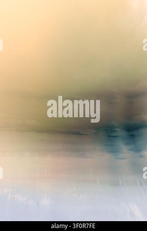 Horizontal conceptual composition with a linear drag effect, simulating a beach horizon under diffused light in shades of beige, ochre, and blue. Stock Photo