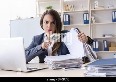 Beautiful female employee unhappy with excessive work Stock Photo