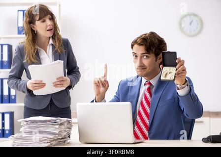 Deaf employee using hearing aid talking to boss Stock Photo