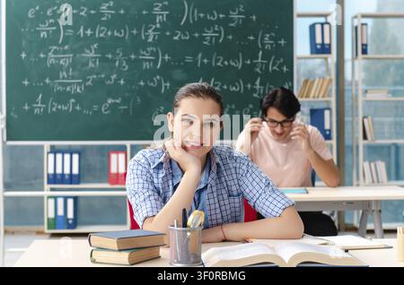 Young students taking the math exam in classroom Stock Photo