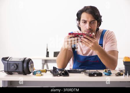 Young male contractor repairing computer Stock Photo