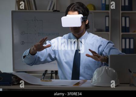 Young male architect working night at office Stock Photo