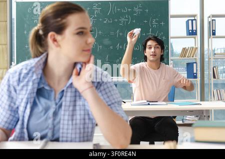 Young students taking the math exam in classroom Stock Photo
