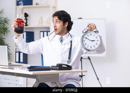 Young handsome doctor in blood transfusion concept Stock Photo