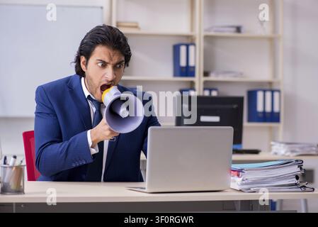 Young handsome businessman working in the office Stock Photo