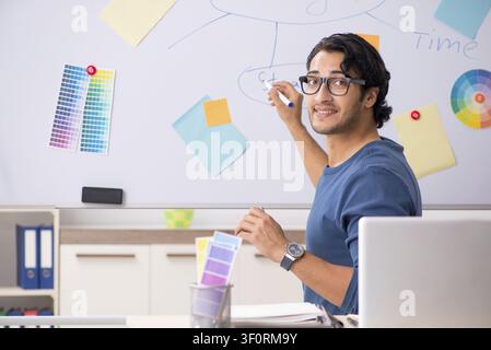 Young handsome designer working at the project Stock Photo